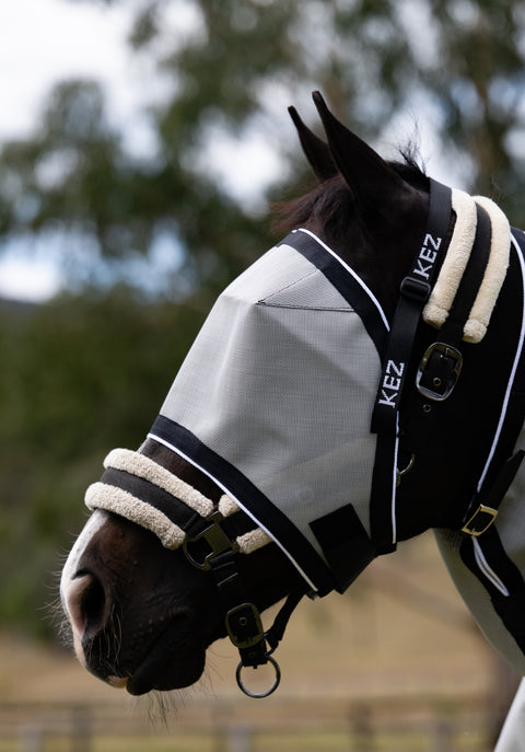 Plain Silver Ultra Mesh Fly Mask without nose attachment, side close-up on a black horse