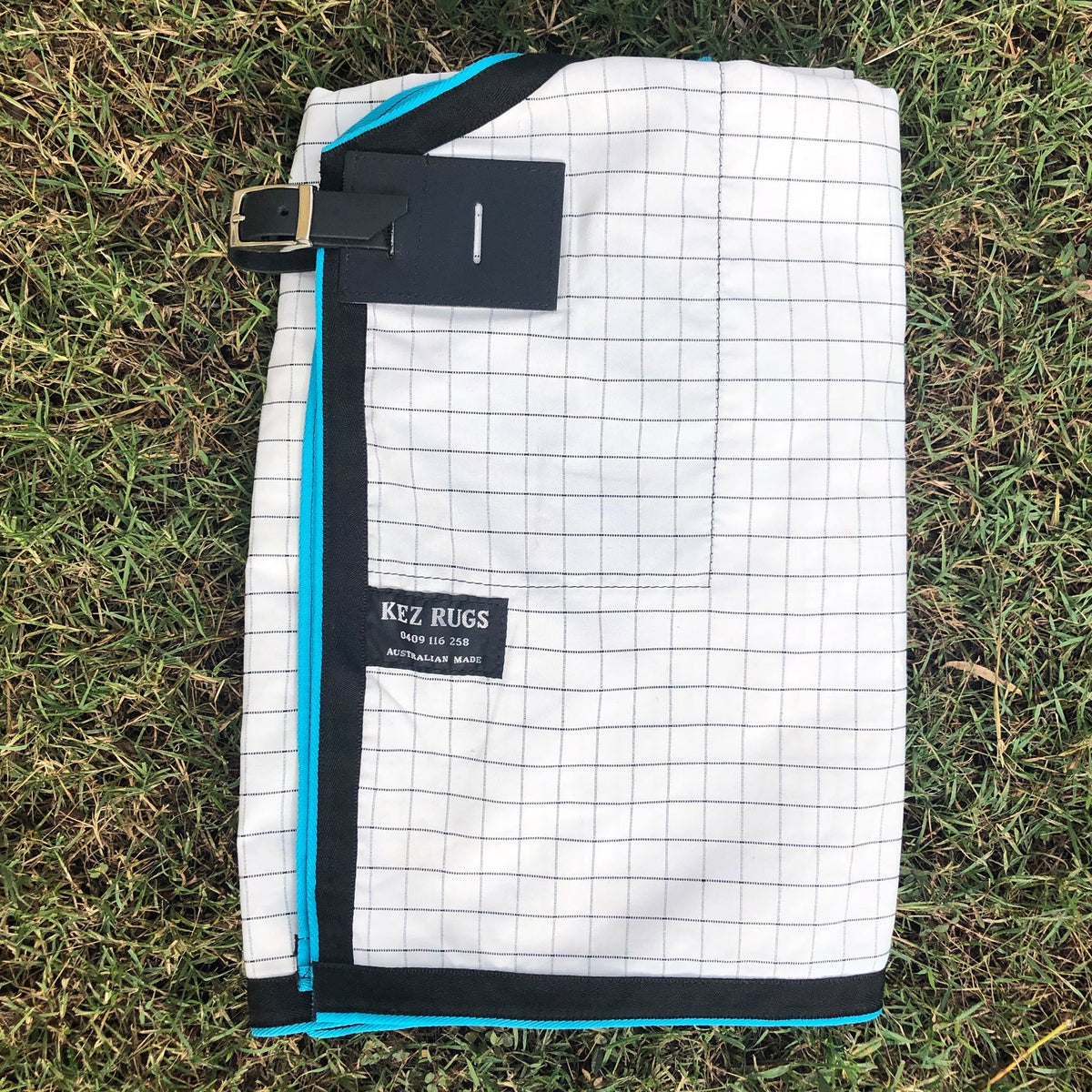 White with Black Check Ripstop rug folded, showing the check and binding